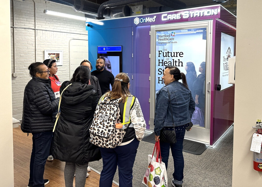 Local families received bags of food, flu shots and health resources, and learned about the innovative OnMed CareStation in their neighborhood at an event at Village South in partnership with OnMed and Hartford HealthCare.